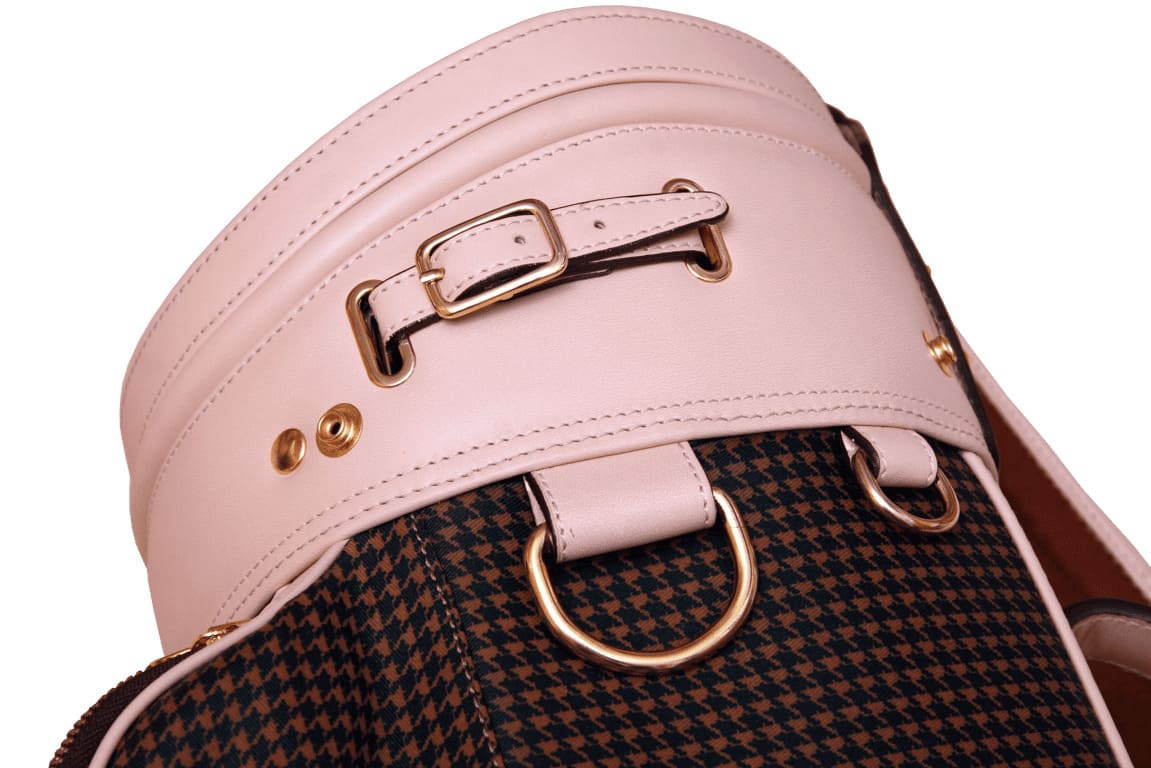 Detail of the gold buckle and premium leather finish on a women's golf bag.