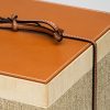 Wooden and leather box with natural wool blanket lid corner detail