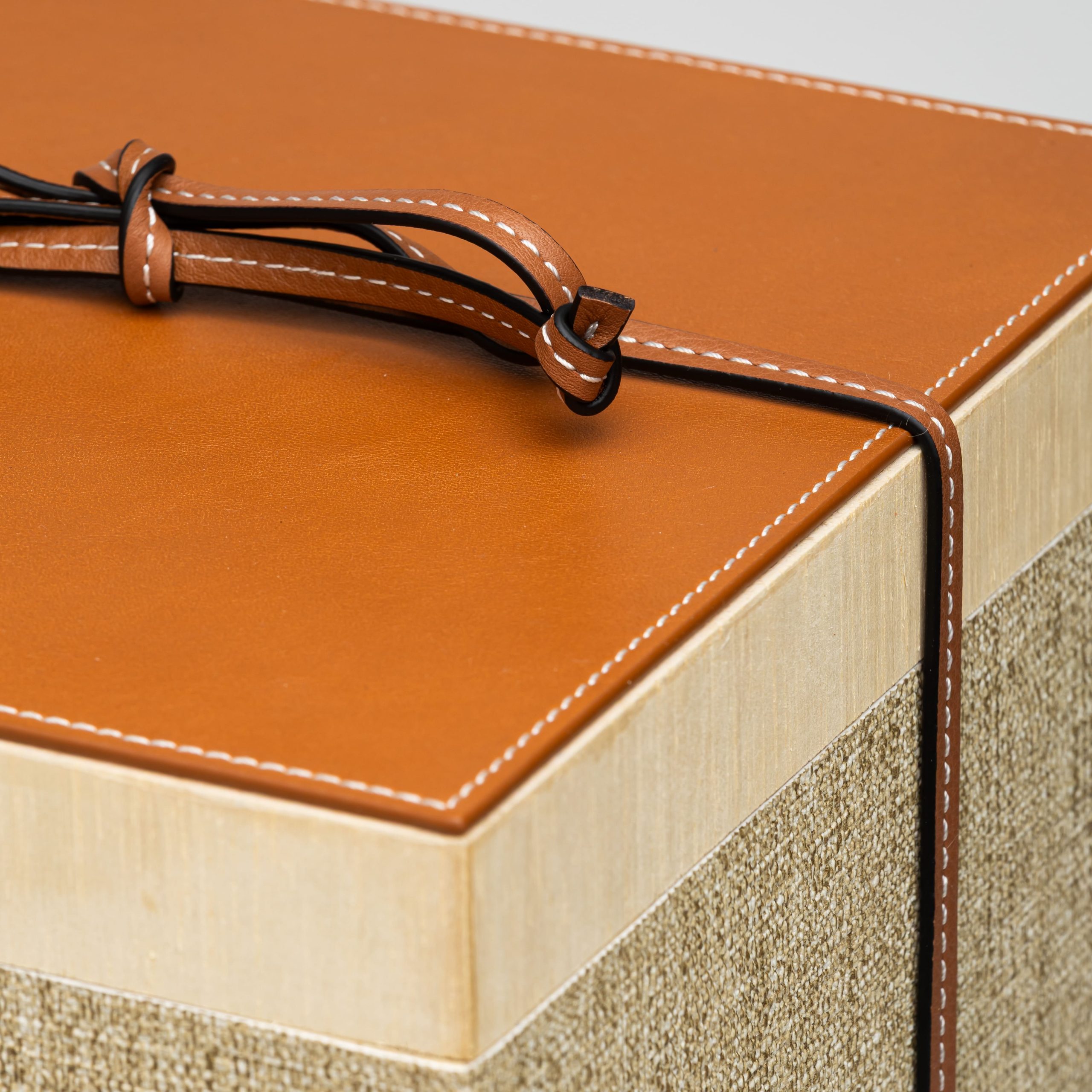 Wooden and leather box with natural wool blanket lid corner detail