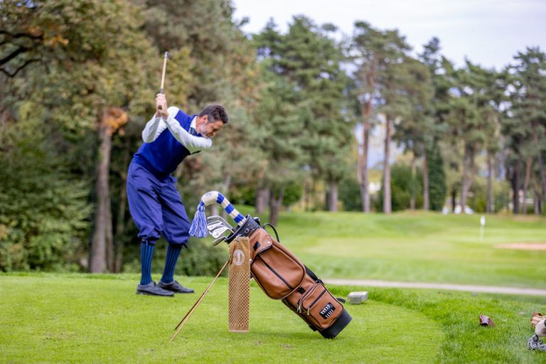 Golfer playing golf with leather bag