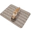 Dog eating from a bowl on an ethnic design pet food mat that keeps the feeding area clean.