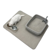 White cat eating from bowls on a sand waterproof canvas pet food mat protecting the floor.